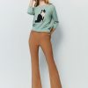Flared pants with asymmetrical hem breasted