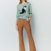 Flared pants with asymmetrical hem breasted