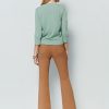 Flared pants with asymmetrical hem breasted